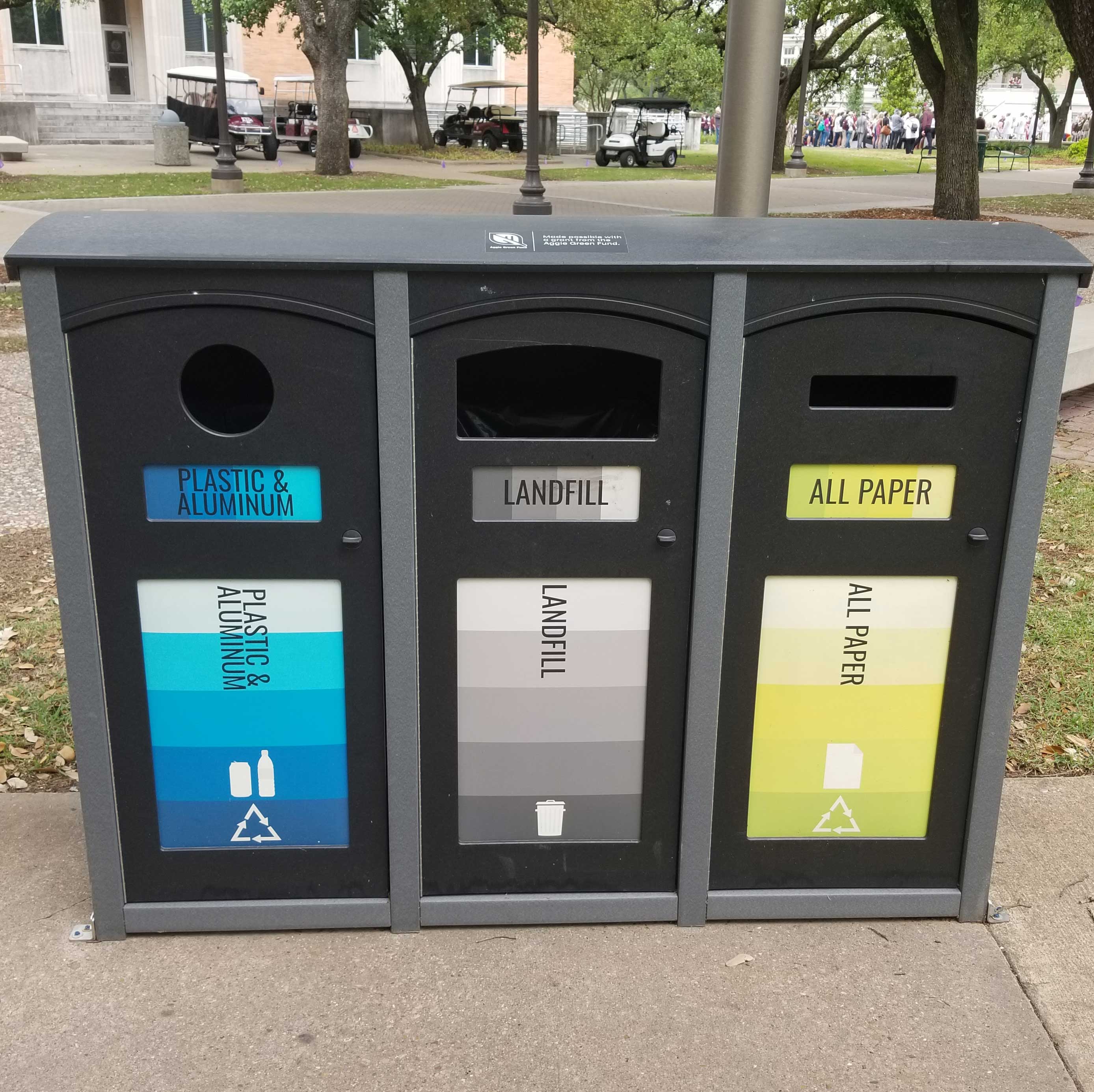 Three-section exterior recycling bin.