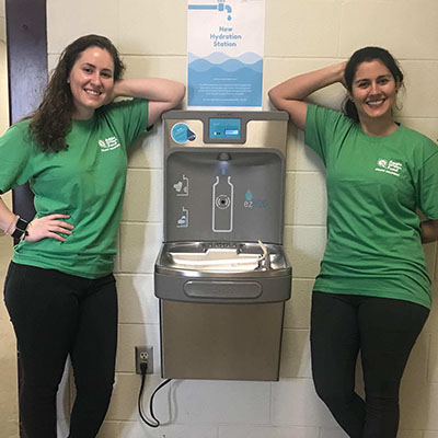 Students posing next to the hydration station in the Horticulture Forest Science Building.
