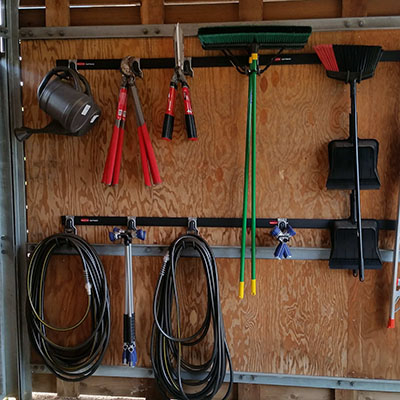 Tools on the wall of the shed at the Gardens Volunteer program.